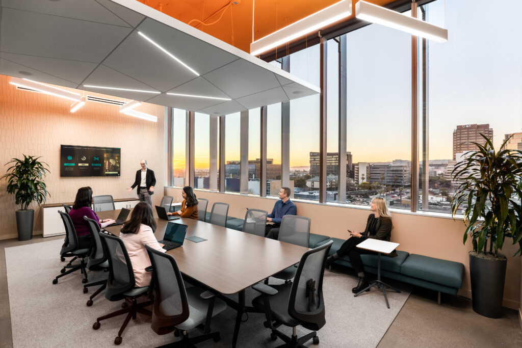 Boardroom overlooking Phoenix, Arizona with staff and executives holding a meeting.