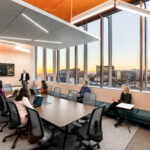 Boardroom overlooking Phoenix, Arizona with staff and executives holding a meeting.